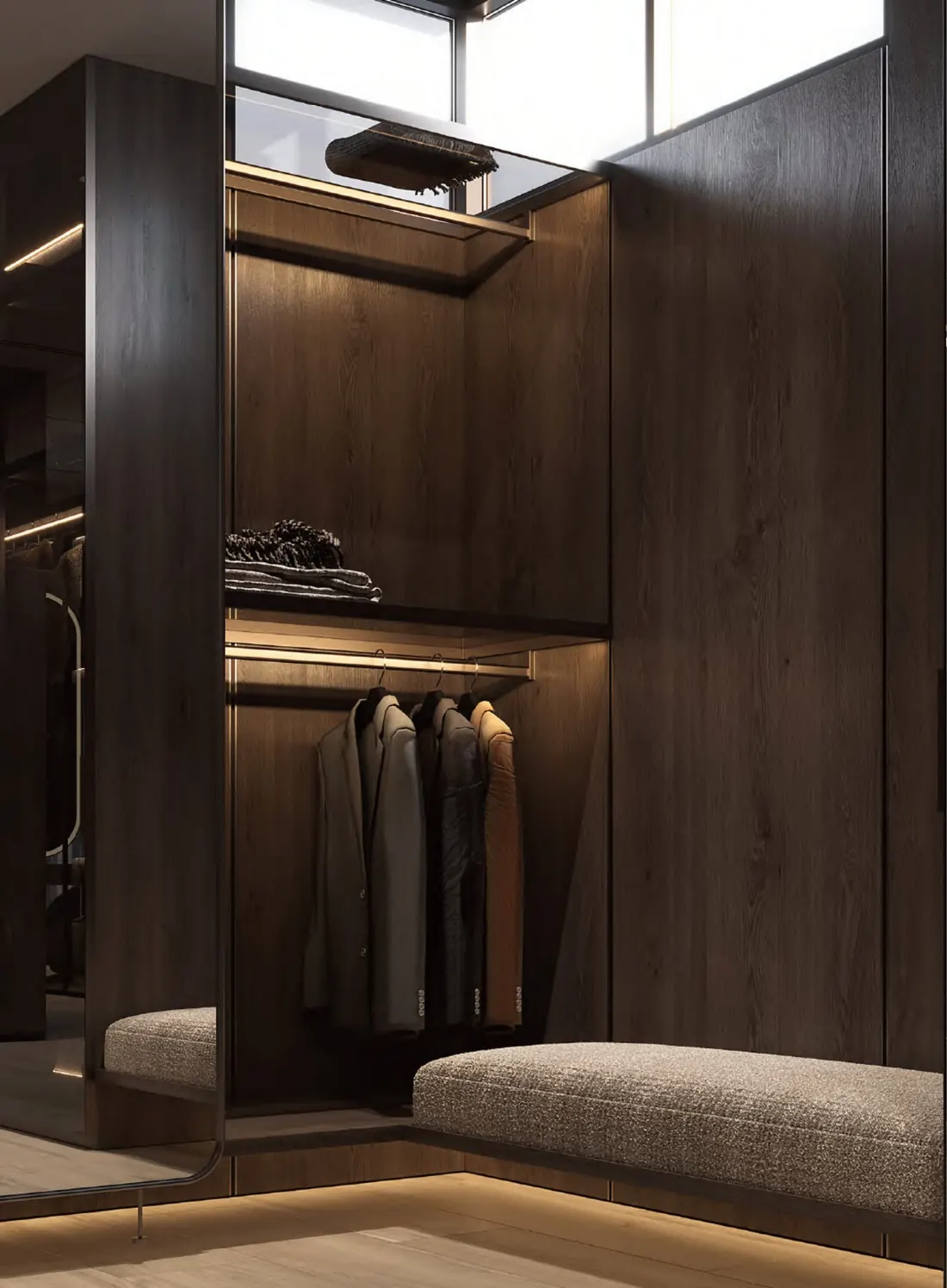 Dark wood walk-in wardrobe with lit hanging section
